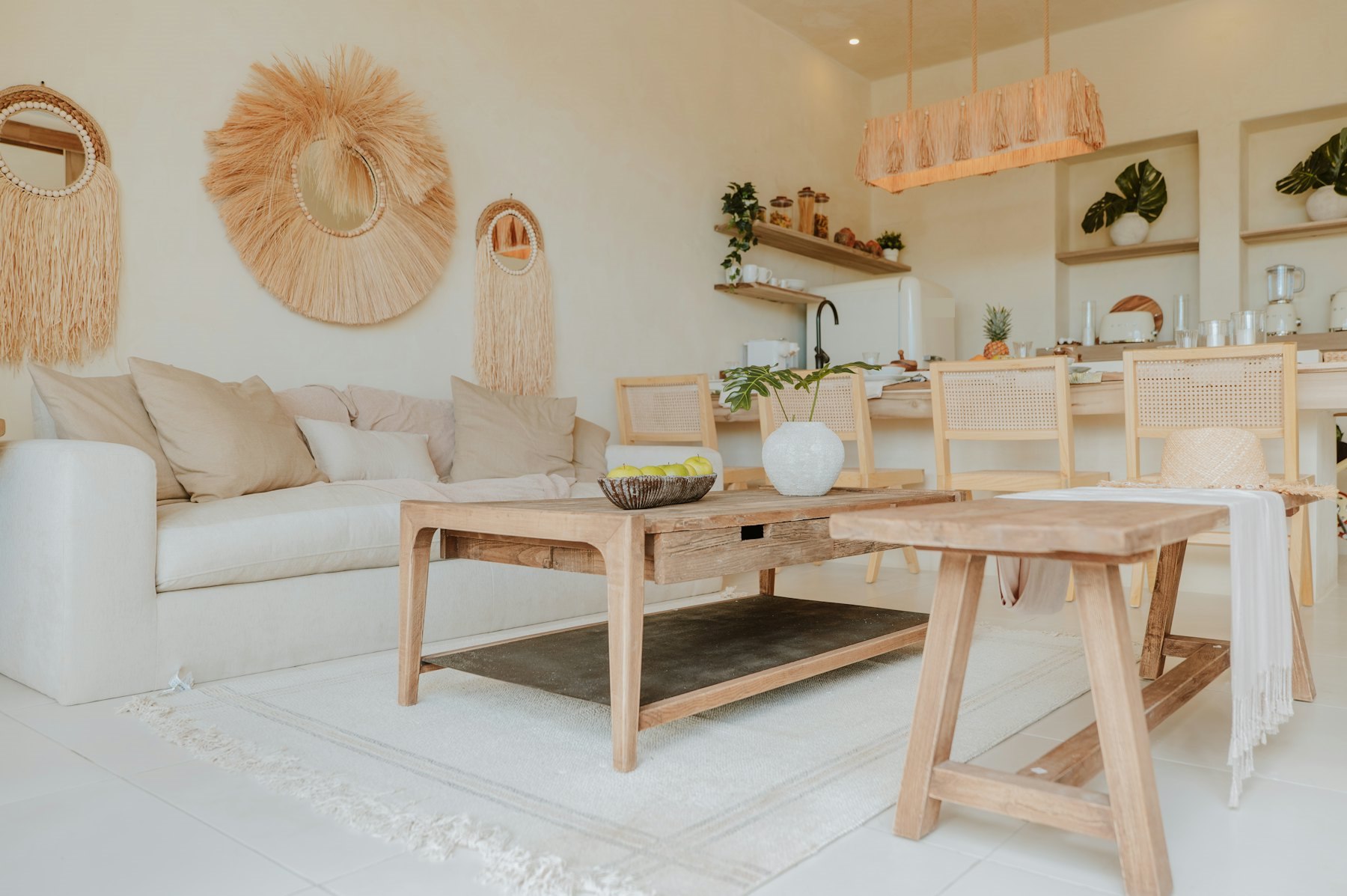 A bright living room with a cream sofa, a wooden coffee table and natural decor