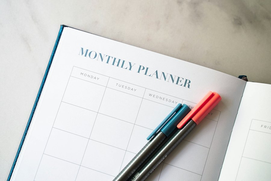 An open monthly planner with two pens